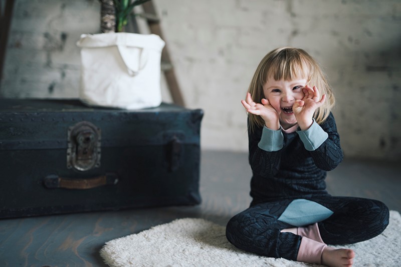 A young girl playing on the floor.