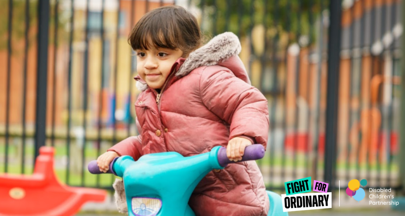 An image of a young child on a bike in a playground